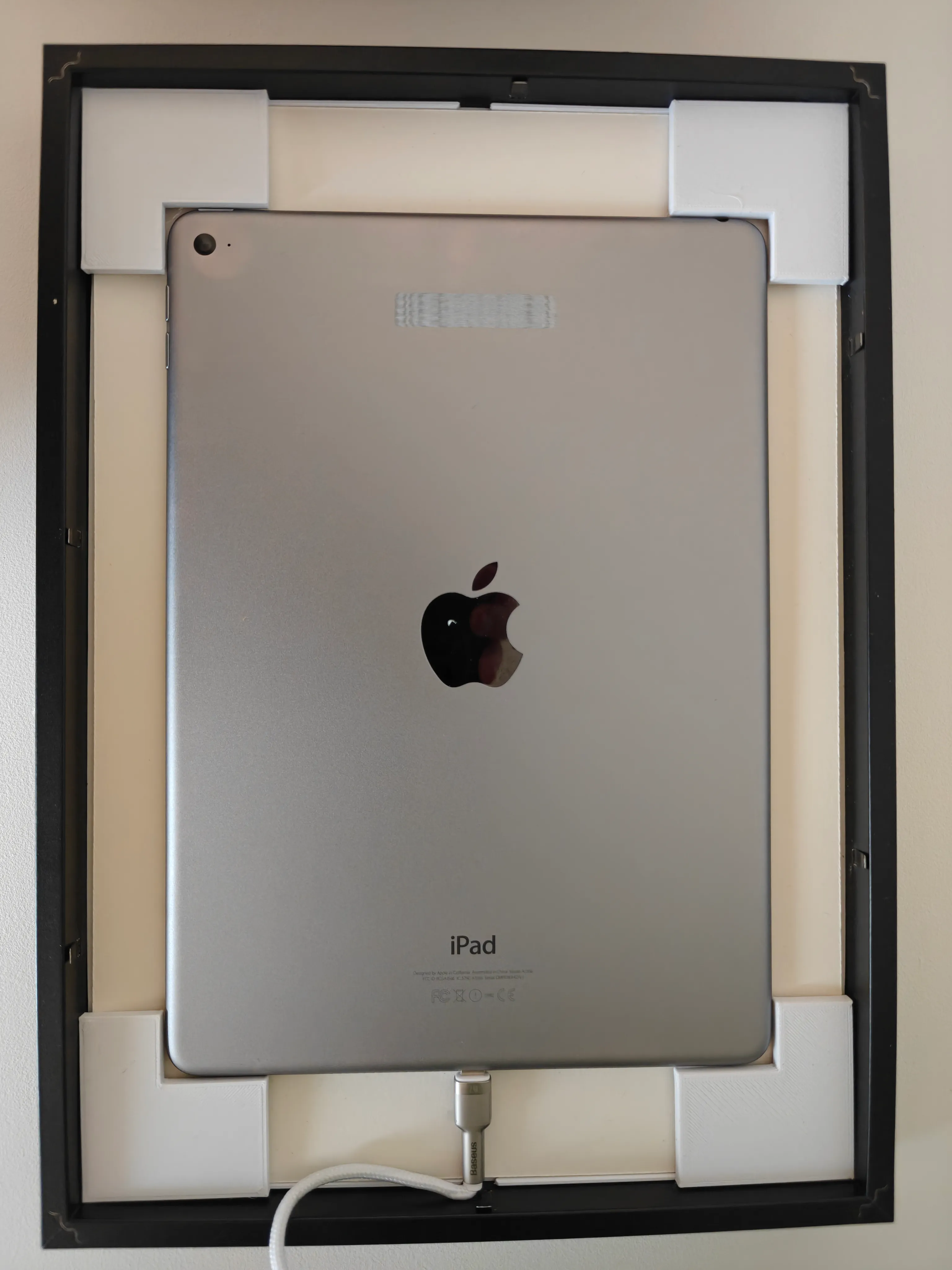 4 spacers in corners, holding iPad in the center of frame